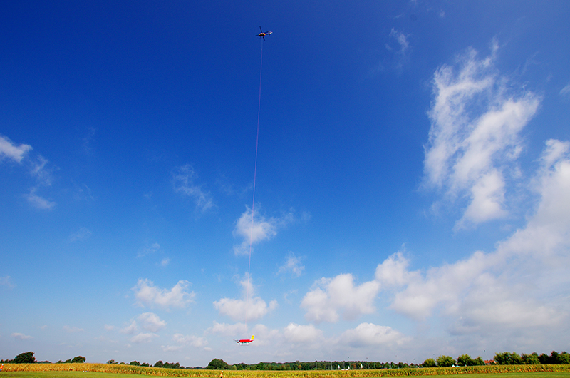 Die mit verschiedensten Sensoren ausgestattete Hubschrauberplattform ACTOS und der Schleppkörper SMART-Helios werden hängen an einem langen Seil und werden per Hubschrauber zu den Wolken gebracht. Foto: Holger Siebert, TROPOS